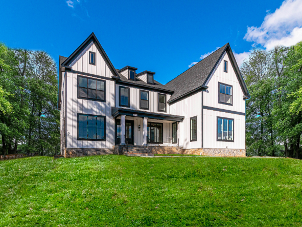 Exterior of the Hampton II. White vertical siding with a brown rood.